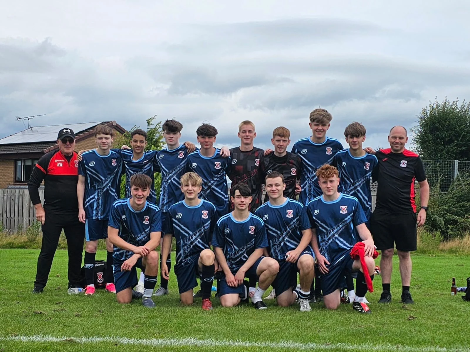 Grassroots team and coaches wearing navy FTACT match kit